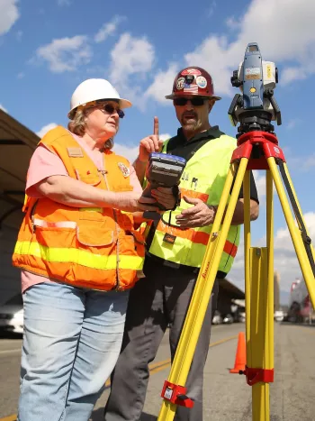 Two surveyors on the street